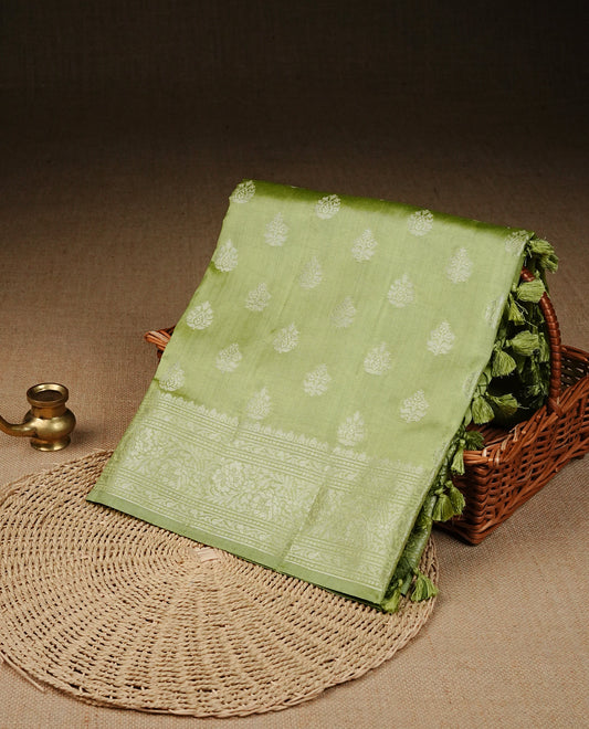 Pastel Gren Colour Tussar silk saree with silver zari buttas On Body, a Contrast  Self Coloured zari border and pallu, Paired With a matching blouse piece.
