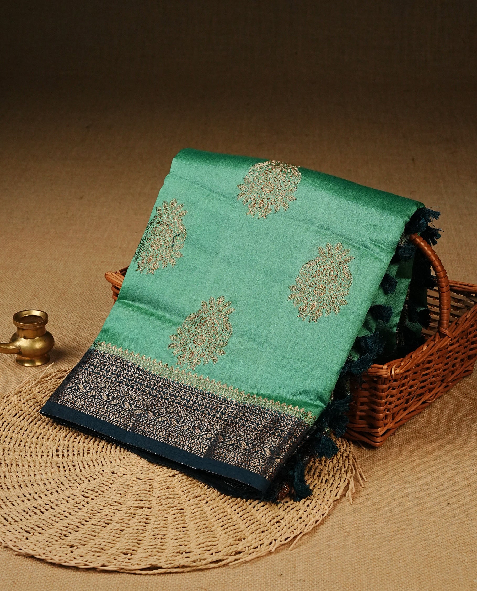 Pastel Aqua Green Colour Tussar Silk saree with elegant antique zari floral motifs On Body, a contrasting Peacock blue zari border, a rich zari pallu, Paired With a matching  blouse piece.
