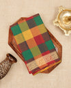 Multi colour Chettinad cotton saree featuring a check pattern on the body, complemented by a self colour with gold zari border, comes with a matching blouse piece