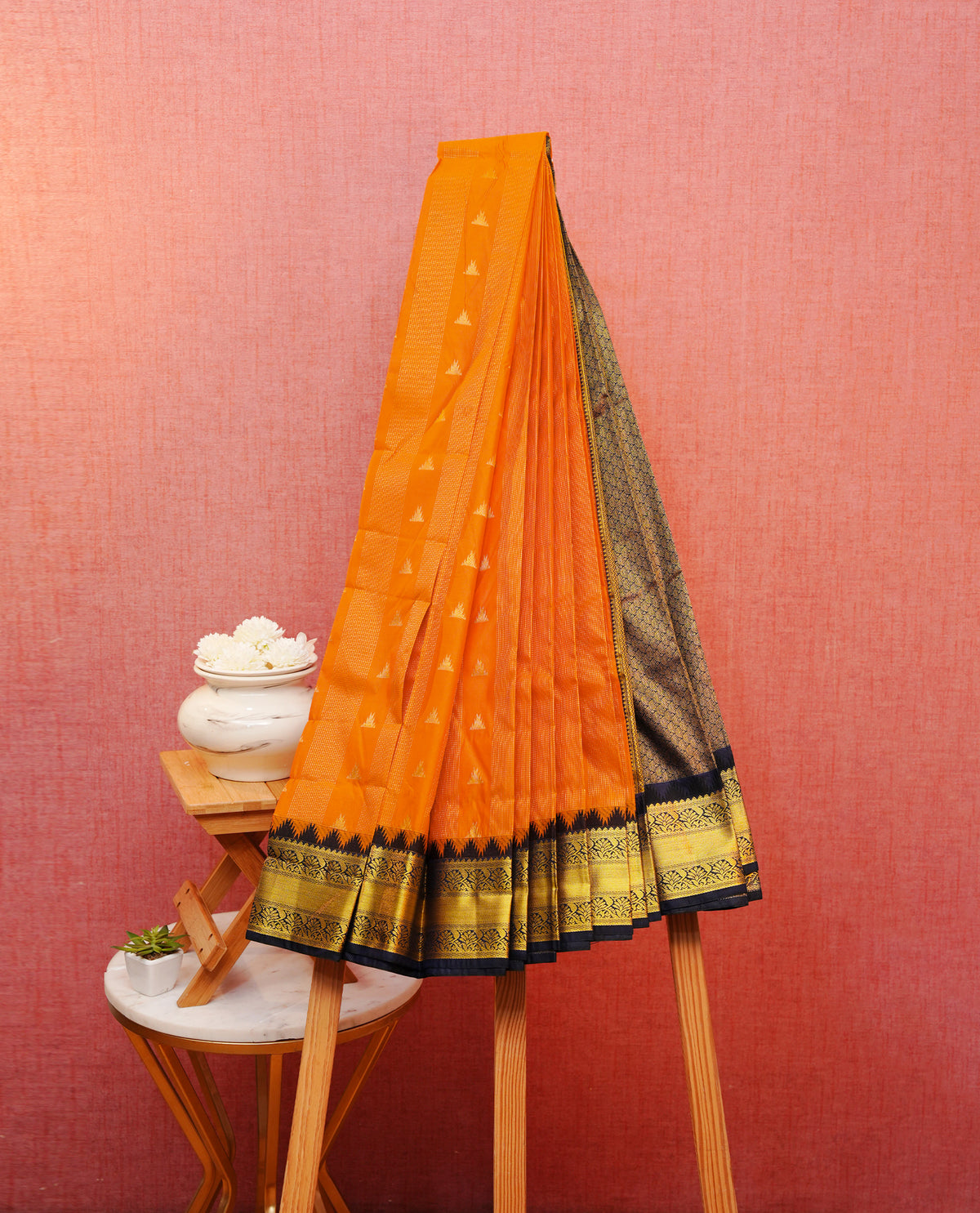 Orange colour silk saree featuring gold zari stipes on body, contrast navy blue with gold zari traditional border, contrast grand pallu comes with matching blouse piece .
