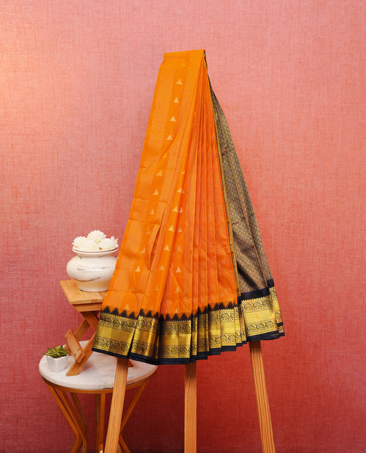 Orange colour silk saree featuring gold zari stipes on body, contrast navy blue with gold zari traditional border, contrast grand pallu comes with matching blouse piece .