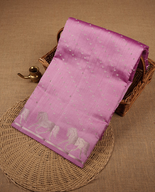 Pastal Purple colour banaras soft silk saree featuring silver zari dotted stripes on body, self colour border with silver horse pattern, pallu and paired with matching blouse.