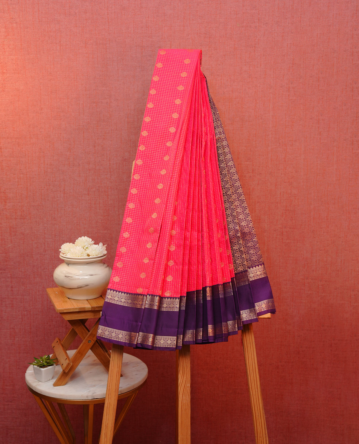 Rani pink colour soft silk saree featuring gold zari checks with buttas on body, contrast dark purple colour gold zari traditional border, grand pallu comes with matching blouse piece.