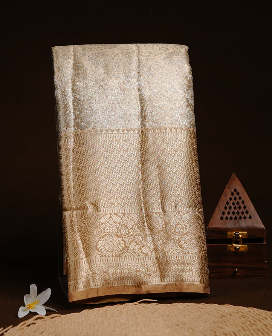 Light Gold colour semi tissue silk saree featuring silver zari pattern on body, contrast gold colour with gold zari traditional border, paired with matching blouse piece.