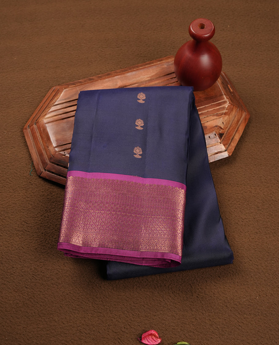Navy blue colour Soft silk saree featuring gold zari motifs on the body, complemented by a contrast magenta traditional zari border and pallu, paired with a matching blouse piece.