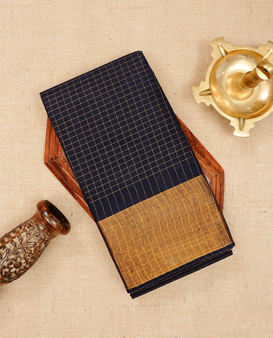 Navy blue colour Sungudi cotton saree featuring elegant gold zari checks across the body, complemented by a contrast gold zari border. Comes with a matching blouse piece.