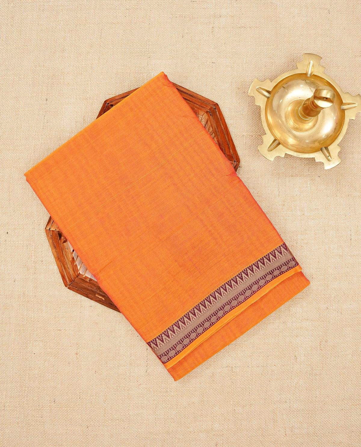 Orange colour colour Narayanapattu cotton saree with a plain body, complemented by a wine Colour with Beige colour border & contrast pallu, paired with a matching blouse piece.