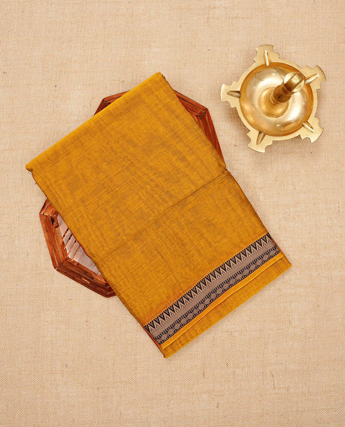 Dark mustard colour  Narayanapattu cotton saree with a plain body, complemented by a Brown With Coffee brown colour with temple designed border & contrast pallu, paired with a matching blouse piece