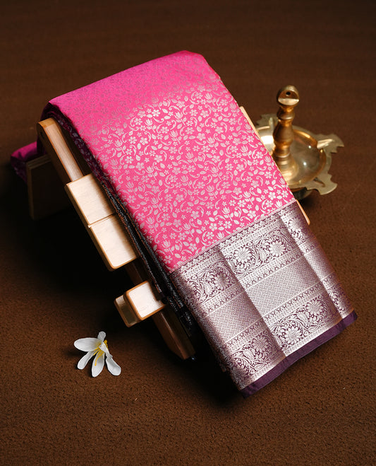 Magenta colour semi wedding saree featuring gold zari floral kodi pattern on body, complemented by contrast chocolate brown with traditional border, paired with matching blouse piece.