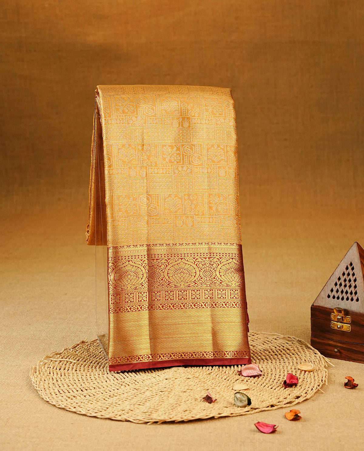 Mustard colour Semi Tissue Silk Saree featuring gold zari Works on the body, complemented by an intricately woven gold zari pallu, a rich Maroon border with gold zari work and paired with a matching plain blouse piece.