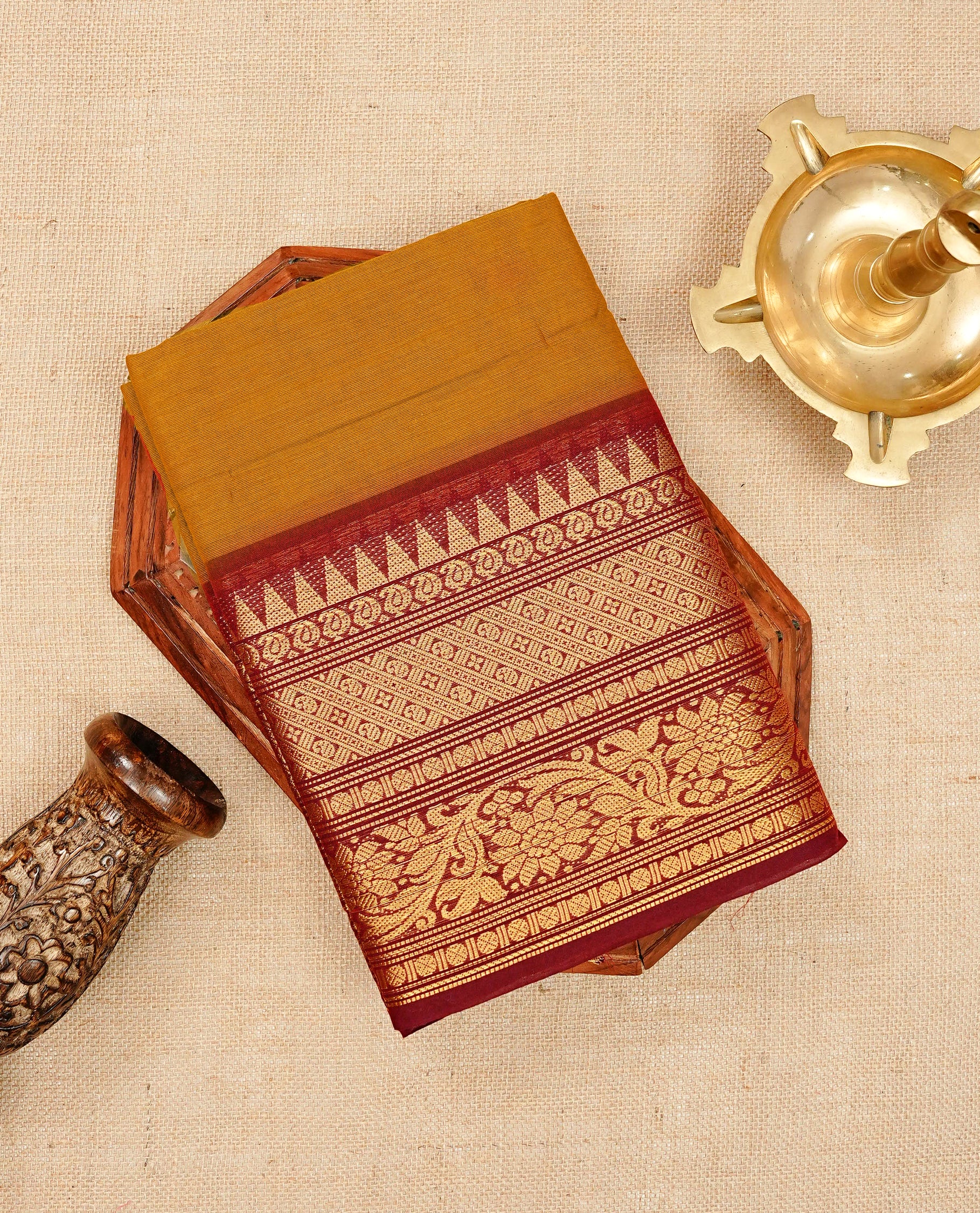 Brick colour chettinad cotton saree featuring elegant plain body, Contrast maroon colour with Gold zari border, comes with matching blouse piece.