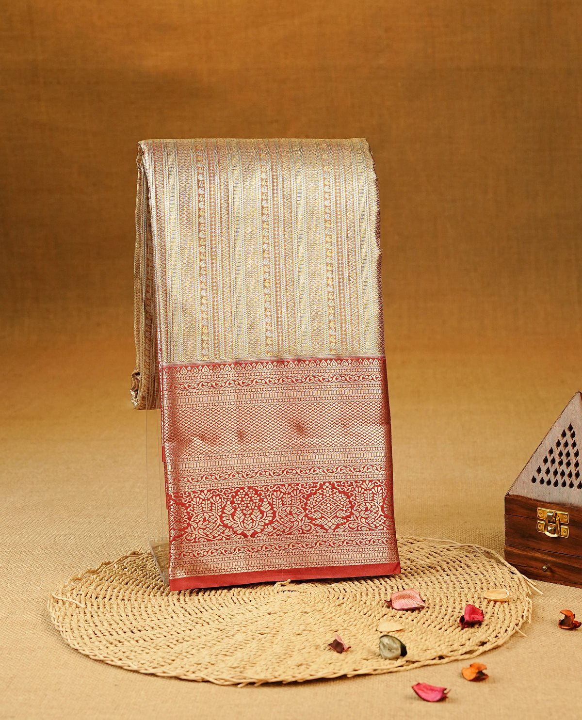 Pastel red colour Semi Tissue Silk Saree featuring Silver zari Works on the body, complemented by an intricately woven Silver zari pallu, a rich Maroon border with silver zari work and paired with a matching plain blouse piece.