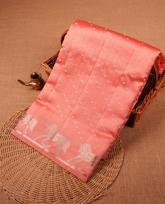Pastal peach colour banaras soft silk saree featuring silver zari dotted stripes on body, self colour border with silver horse pattern, pallu and paired with matching blouse.