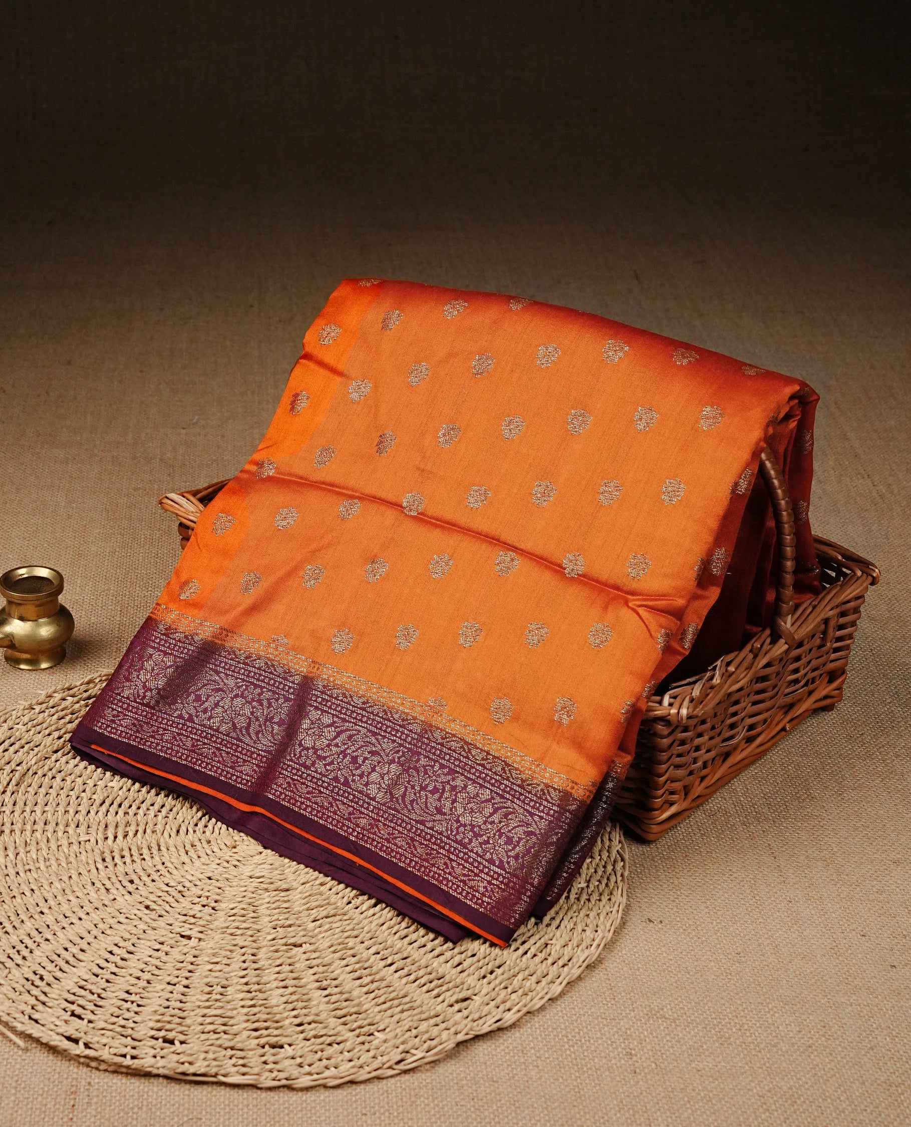 Radiant orange Colour Tussar silk saree with antique zari buttas On Body, a rich Wine floral zari border, an elegant floral zari pallu, Paired With a matching blouse piece.