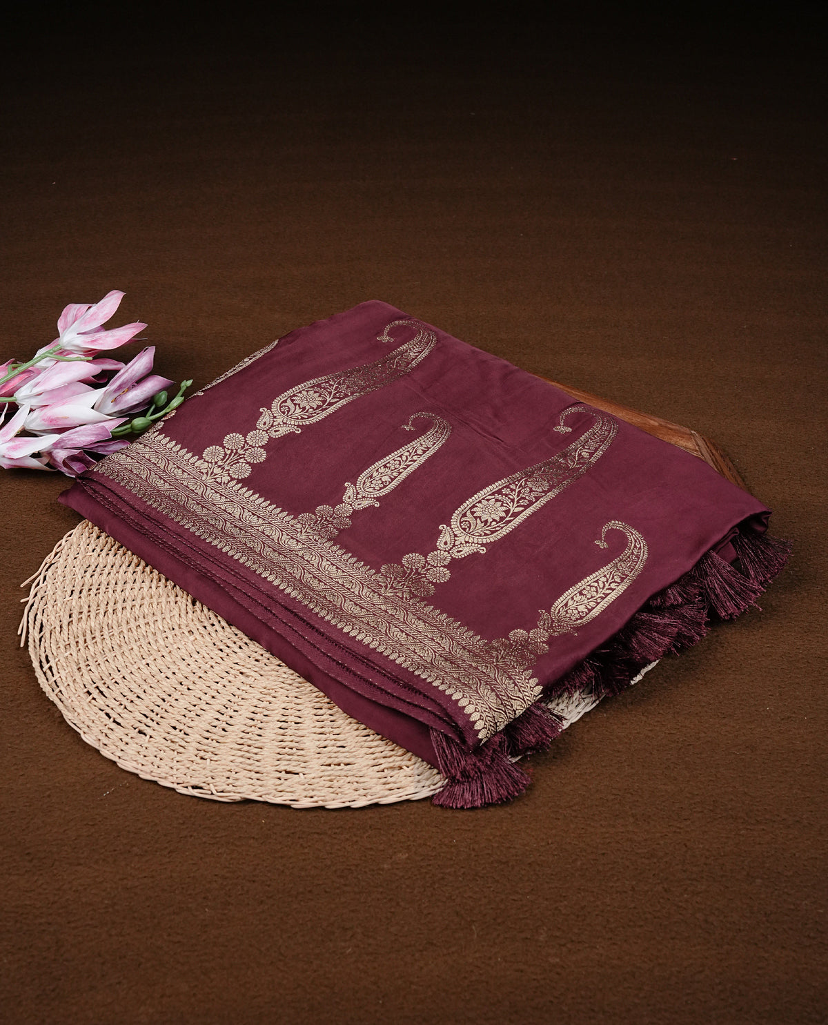 Maroon colour Banaras satin crepe silk saree featuring Plain body, associate with Gold zari traditional border, comes with matching blouse piece.