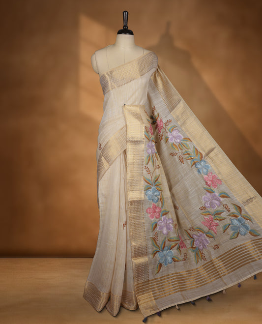 Beige colour Banarasi linen silk saree featuring hand brushed colour with Floral  & birds printed pattern on body, gold zari woven geometric design border with self colour pallu and comes with a matching blouse