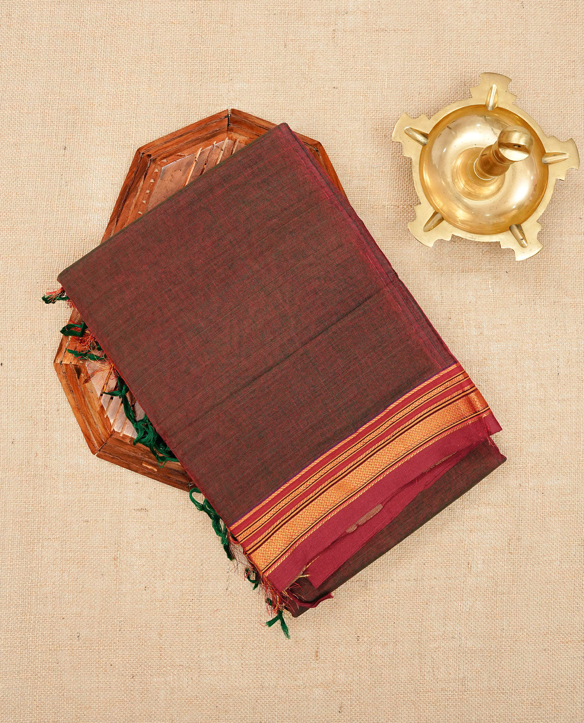 Green & Brown dual shade Narayanapattu cotton saree with a plain body, complemented by a maroon Colour with border with elegant gold zari detailing and a contrast striped pallu, paired with a matching blouse piece.