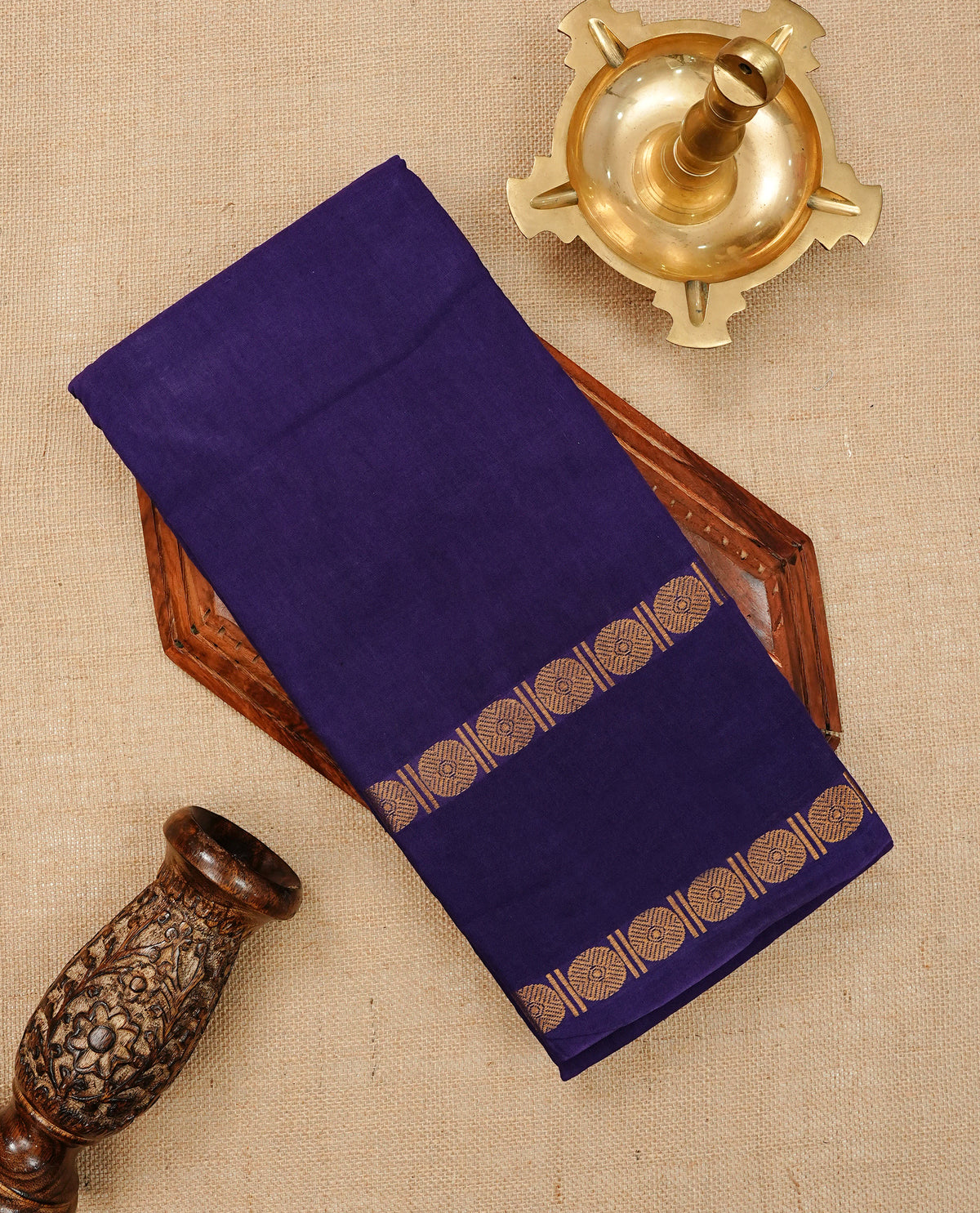 Purple Colour  Sungudi Cotton Saree with gold zari motifs on the body, a matching gold zari border, and a plain pallu. Paired with a contrast Pink colour  blouse piece  featuring a gold zari peacock border.