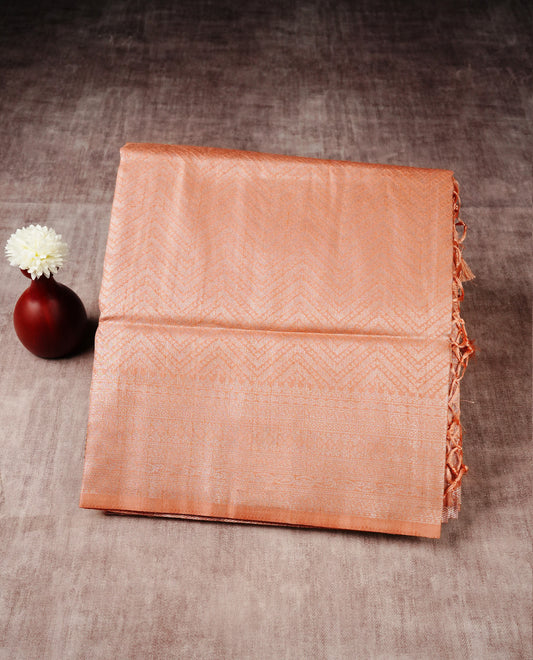 Peach colour softie silk saree featuring silvar zari, rich pallu floral pattern brocade body, with contrasting self colour border.paired with matching blouse piece.
