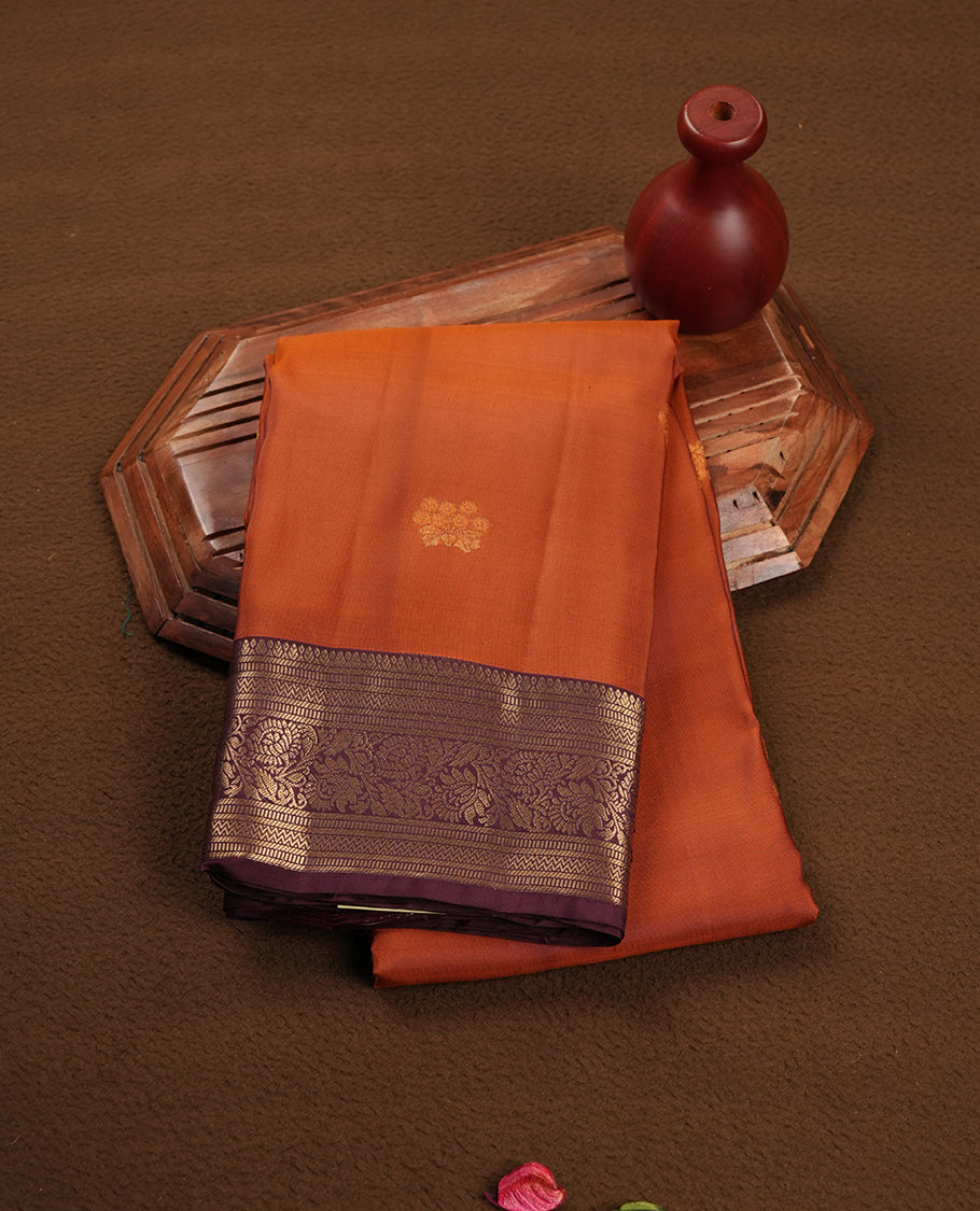 Rust colour soft silk saree featuring gold zari motifs on the body, complemented by a contrast Chocolate traditional zari floral kodi border and pallu, paired with a matching blouse piece.