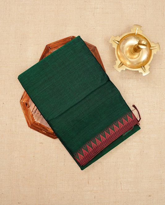 Bottle green colour Narayanapattu cotton saree with a plain body, complemented by a Maroon colour with red temple designed border & contrast pallu, paired with a matching blouse piece.