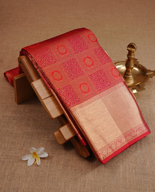 Red colour kancheepuram silk saree featuring gold zari Box pattern on body, complemented by self colour with traditional border, paired with matching blouse piece.