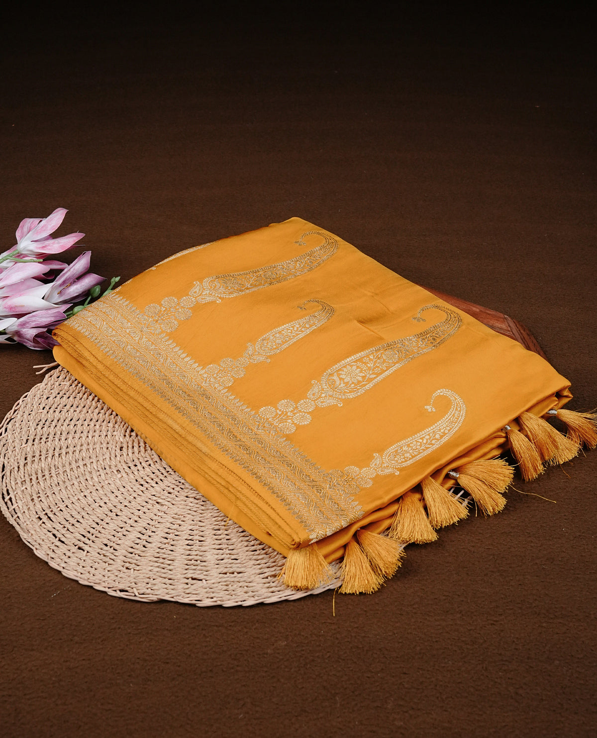 Yellow colour Banaras satin crepe silk saree featuring Plain body, associate with Gold zari traditional border, comes with matching blouse piece.