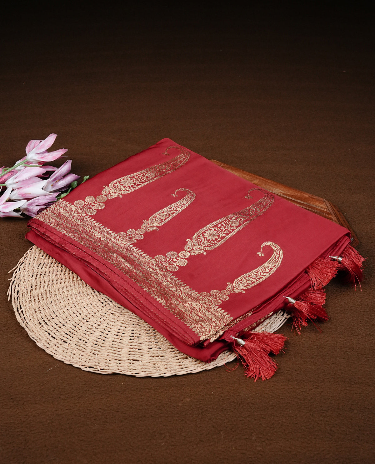 Red colour Banaras satin crepe silk saree featuring Plain body, associate with Gold zari traditional border, comes with matching blouse piece.