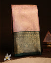 Baby pink colour semi tissue silk saree featuring gold zari floral kodi pattern on body, contrast green colour with gold zari traditional border, paired with matching blouse piece.