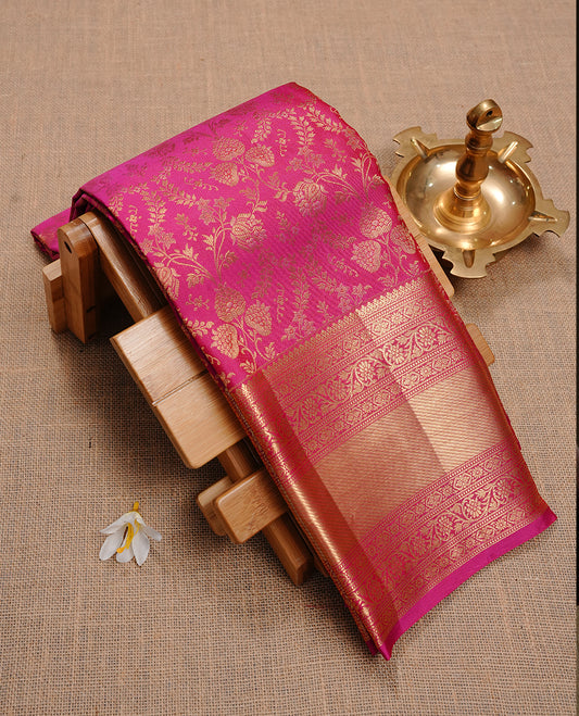 Magenta colour kancheepuram silk saree featuring gold zari floral kodi pattern on body, complemented by self colour with traditional border, paired with matching blouse piece.