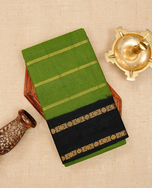 Green Sungudi cotton saree featuring elegant gold zari stripes on the body, complemented by a contrast black with gold zari border and pallu, paired with a matching blouse piece