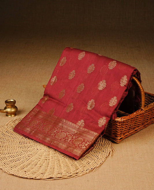 Red colour Banaras silk saree featuring gold zari motifs on body, complemented by contrast self colour with zari border, comes with matching blouse piece.