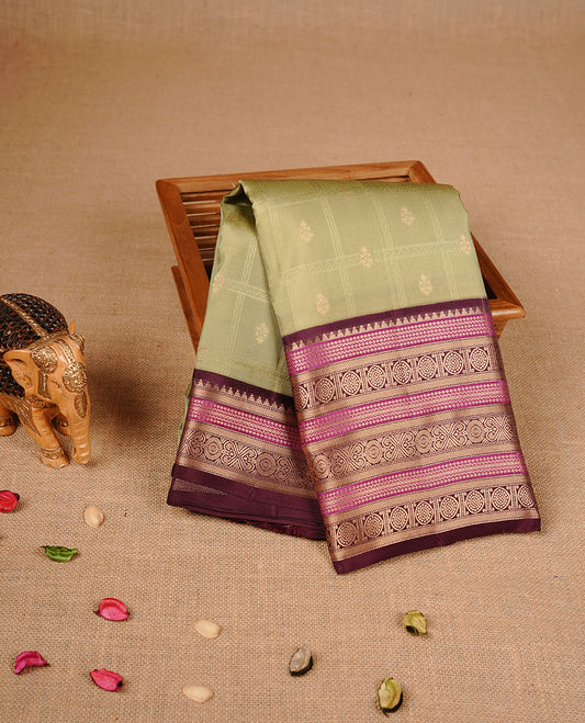 Spanish olive colour traditional kancheepuram silk saree featuring gold zari check pattern on body, complemented by contrast Maroon & magenta colour with gold zari traditional border, paired with matching blouse piece.