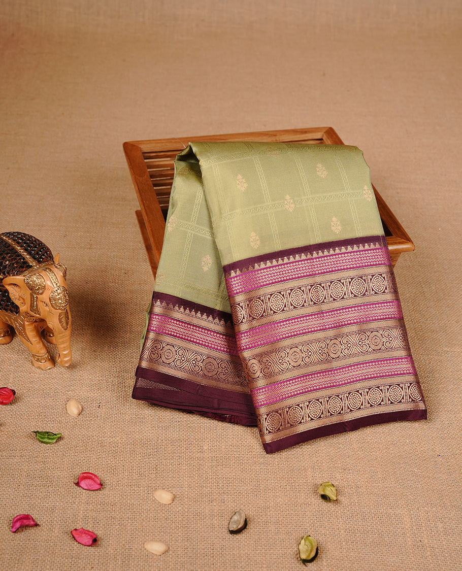 Spanish olive colour traditional kancheepuram silk saree featuring gold zari check pattern on body, complemented by contrast Maroon & magenta colour with gold zari traditional border, paired with matching blouse piece.