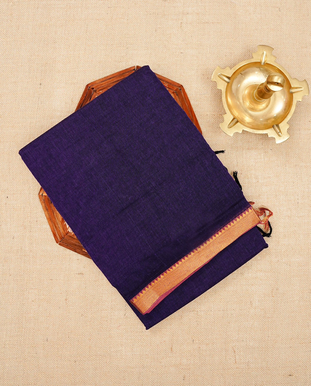 Purple colour Narayanapattu cotton saree with a plain body, complemented by a magenta Colour with Gold Zari border & contrast pallu, paired with a matching blouse piece.