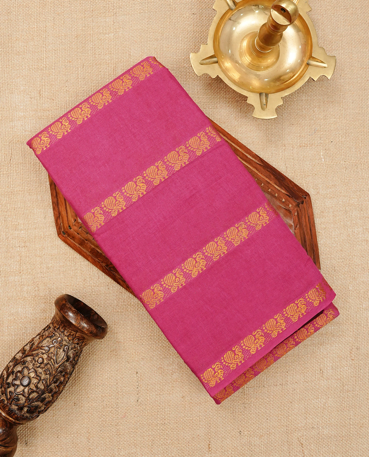 Magenta Colour Sungudi Cotton Saree with peacock gold zari stripes on the body, a matching gold zari border, and a striped gold zari pallu. Paired with a contrast Brown blouse piece  featuring gold zari work.