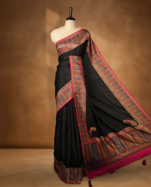 Black colour Pashmina silk saree plain body, framed by an opulent arabesque border and grand storytelling pallu, paired with a matching woven border blouse piece