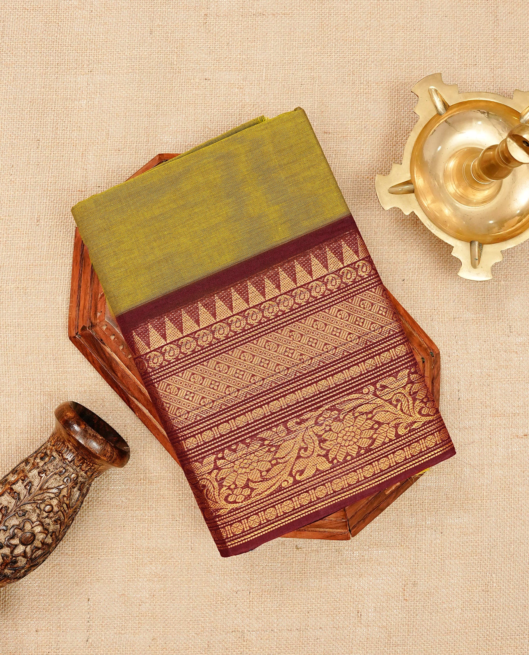Olive colour chettinad cotton saree featuring elegant plain body, Contrast maroon colour with Gold zari border, comes with matching blouse piece.