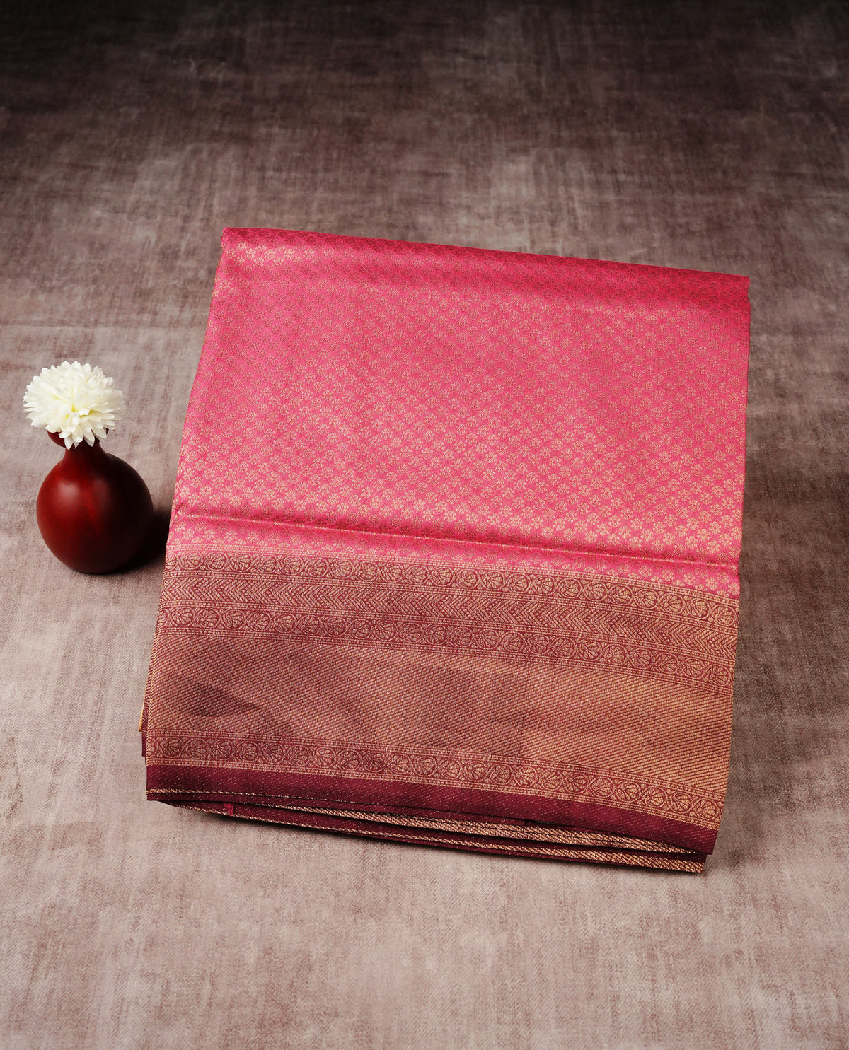 Pink colour softie silk saree featuring gold zari, rich pallu floral pattern brocade body, with contrasting maroon colour border.paired with matching blouse piece.
