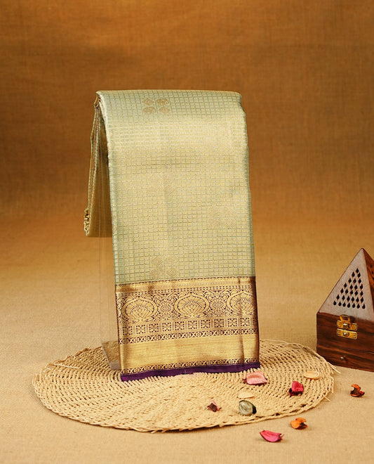 Light Green Colour Semi Tissue Silk Saree featuring Gold Zari Checks with elephant & peacock buttas on the body, complemented by an intricately woven gold zari pallu, a rich Purple and gold zari border, and paired with a matching plain blouse piece