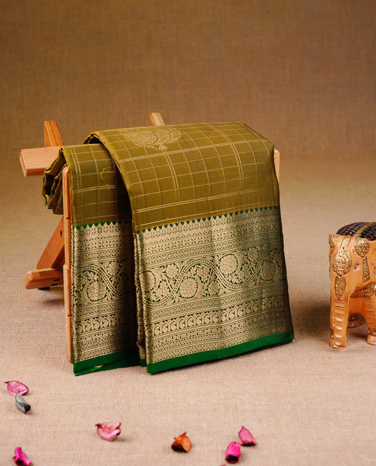 Mustard olive Colour Traditional Kancheepuram Silk Saree with Gold Zari Checks & motifs on the Body, Enhanced with a Contrast Green Colour with Grand Gold Zari  Border and Rich Pallu, Paired with a Matching Blouse Piece.