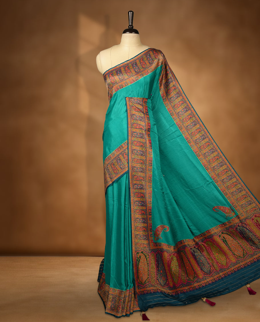 Aqua green colour Pashmina silk saree plain body, framed by an opulent arabesque border and grand storytelling pallu, paired with a matching woven border blouse piece