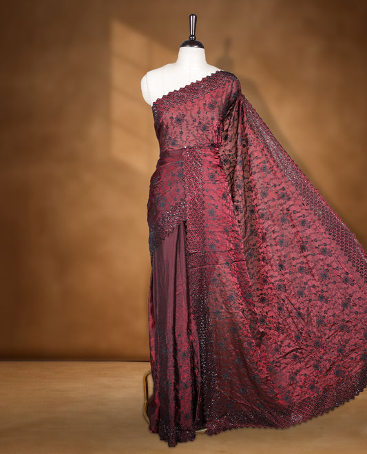 Maroon colour velvet chiffon designer saree, featuring black thread embroidery kodi pattern on body, black cut stone work and heavy stone border, pallu and Paired with matching blouse.