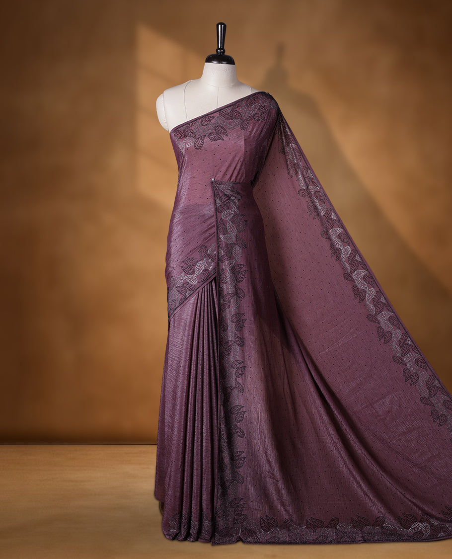 Grape colour chiffon designer saree, featuring black and white scattered stone on body, stone work and heavy stone leaf pattern on border and  pallu, Paired with matching blouse.
