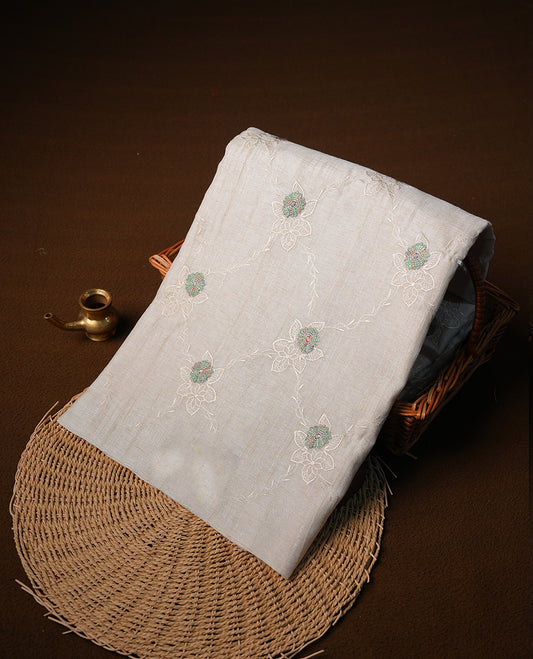 Cream colour semi tuseer silk saree featuring with Self colour thread embroidery kodi pattern & green colour floral thread motifs all over body, pallu, and paired with matching blouse piece.