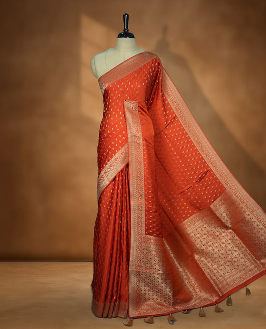 Orange Colour Semi Banarasi Satin Crepe Saree with Silver Zari Buti Motifs, Traditional Gold Ornate Pallu, Elaborate Woven Border, Decorative Tassels with Matching Blouse