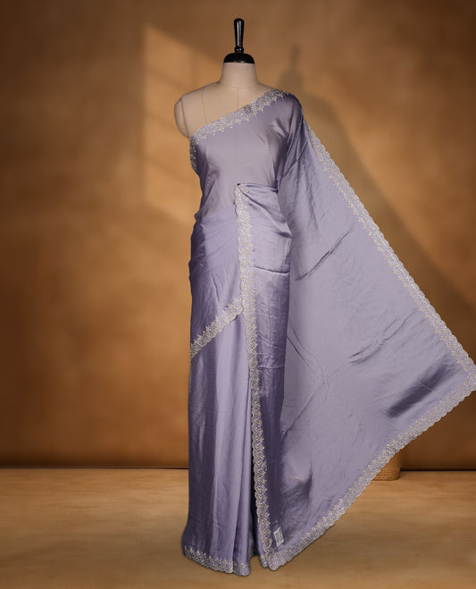 Lavender Colour Chiffon Designer Saree featuring Delicate White Stone motifs on Body, with Stone Detailing on the Border and Pallu, paired with a Matching Blouse.