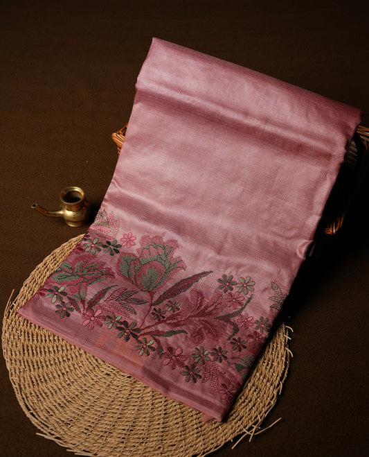 Pastel peach colour Pure tusser silk saree featuring finely crafted floral thread embroidery detailing on the border, pallu and with matching blouse piece.