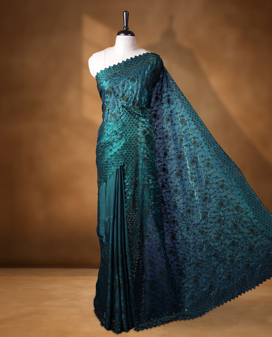 Dark pine green colour velvet chiffon designer saree, featuring black thread embroidery kodi pattern on body, black cut stone work and heavy stone border, pallu and Paired with matching blouse.