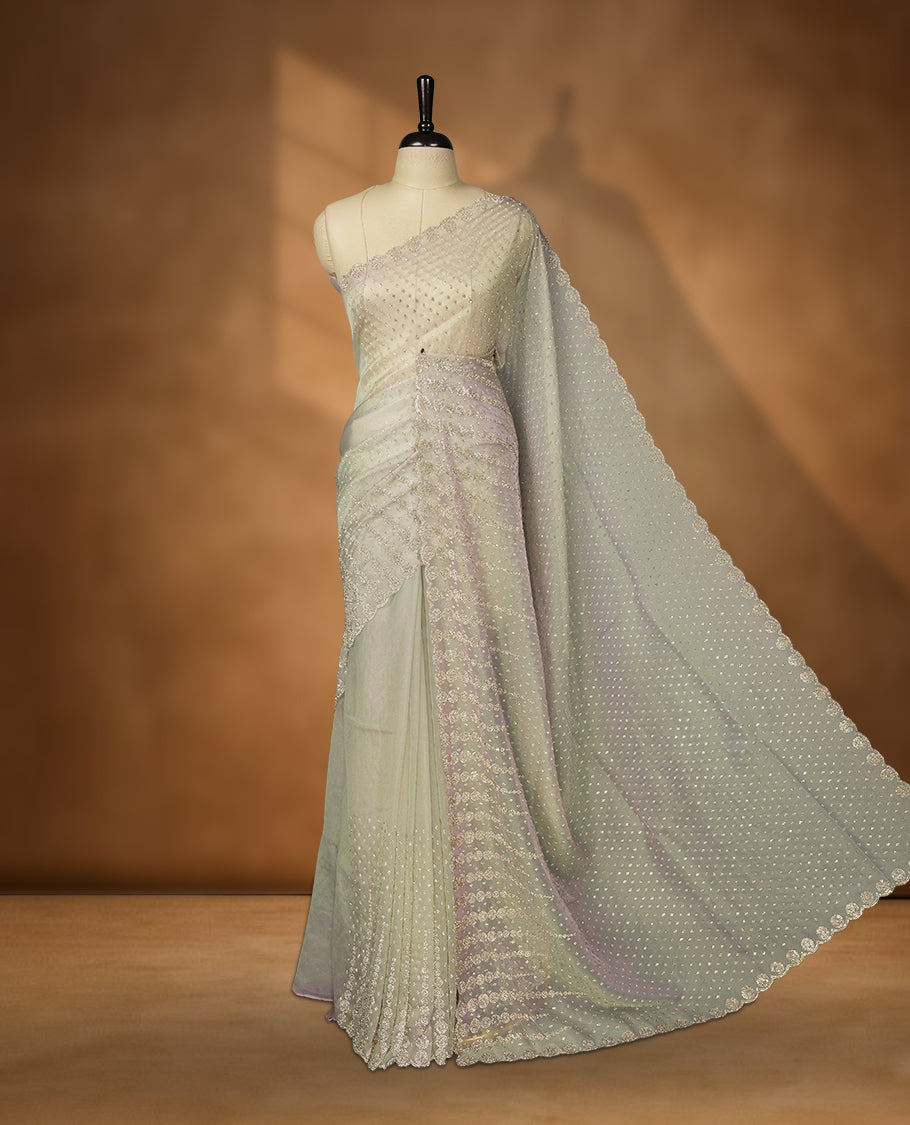 Gray and pink double shade Colour net shimmer fancy saree adorned with scattered white stone buttas all over the body, paired with a delicate stone worked border and matching blouse